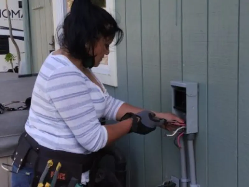 Licensed electrician wiring an exterior subpanel in Frankenmuth